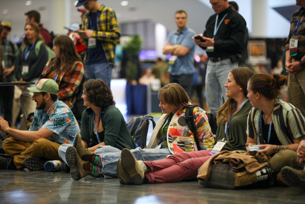 Onlookers of the Harnessing ACCT cable whip showdown smile as participants try their luck at this iconic event hosted at the 2025 conference and exposition.