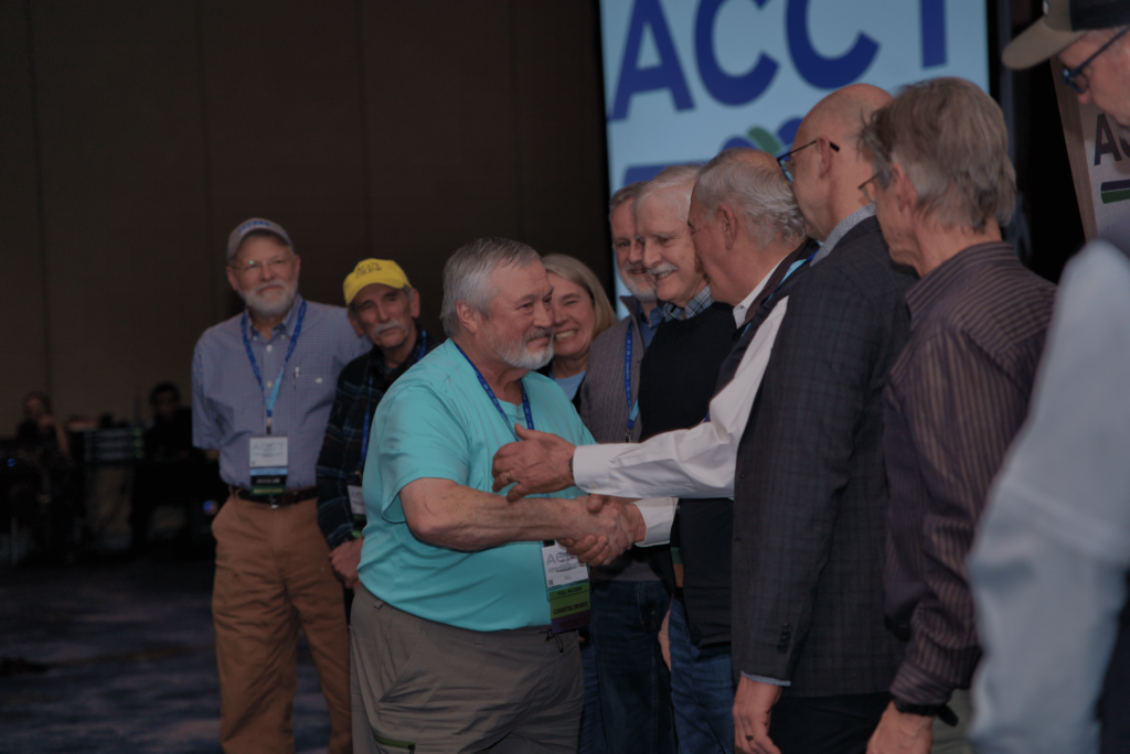 John Winter, the winner of the Critical Link award at the Awards Ceremony, shakes the hands of previous Critical Links during the 2025 ACCT conference and exposition.