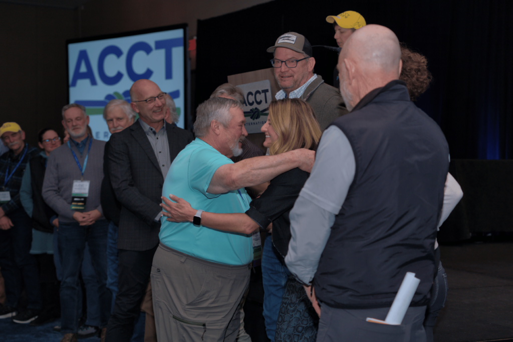 John Winter, the winner of the Critical Link award at the Awards Ceremony, hugs a previous Critical Link recipient during the 2025 ACCT conference and exposition.