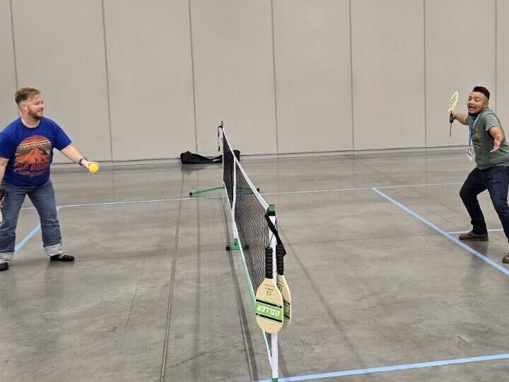 Two members of the Harnessing ACCT team Buckeye Treehuggers play pickleball in the Exhibit Hall thanks to Cuyahoga Community College during the 2025 conference and exposition.