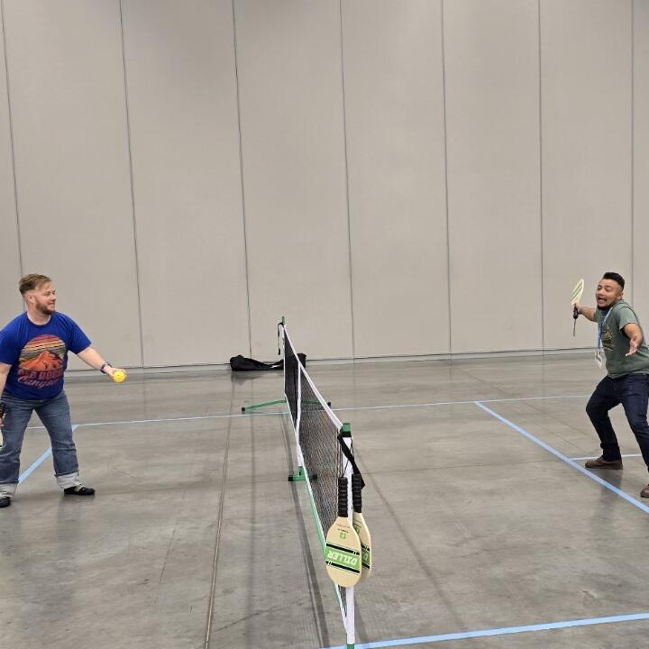 Two members of the Harnessing ACCT team Buckeye Treehuggers play pickleball in the Exhibit Hall thanks to Cuyahoga Community College during the 2025 conference and exposition.