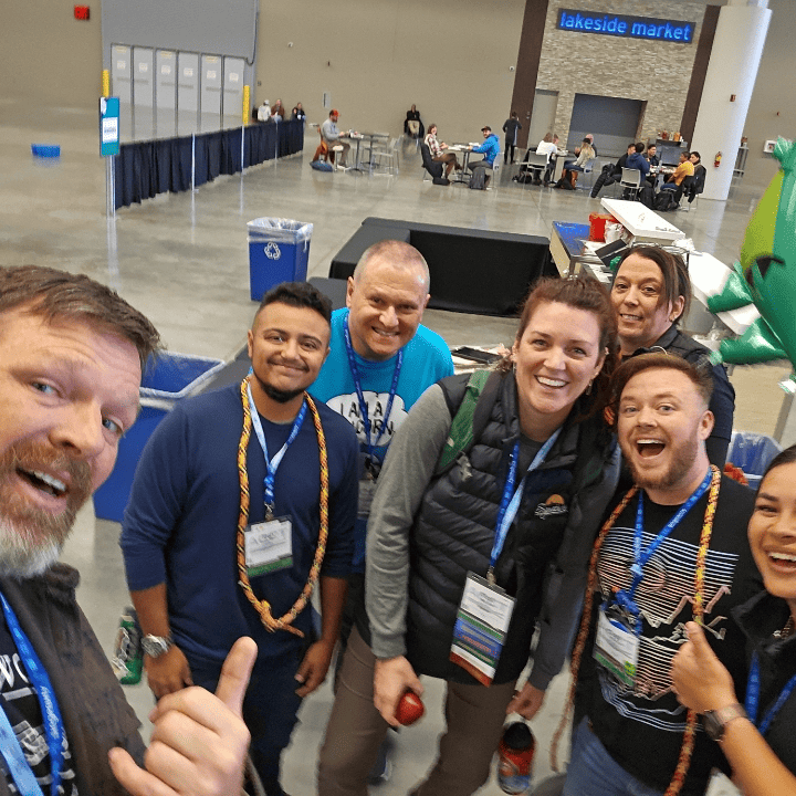 Six members of the Harnessing ACCT team Buckeye Treehuggers smile with Alicia Bourke, and accredited member, in the Exhibit Hall during the 2025 conference and exposition.