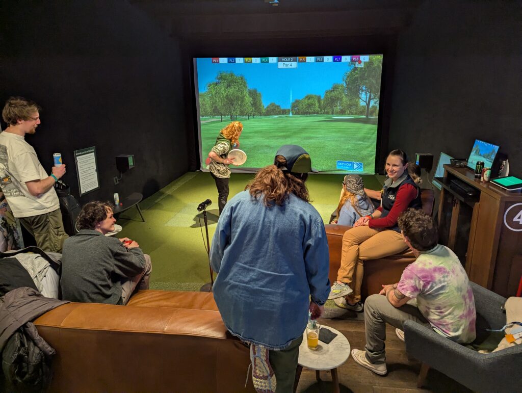 One person utilizes a disc golf simulator at Five Iron Golf during the After Hours Social sponsored by Granite Insurance during the 2025 ACCT conference and exposition.