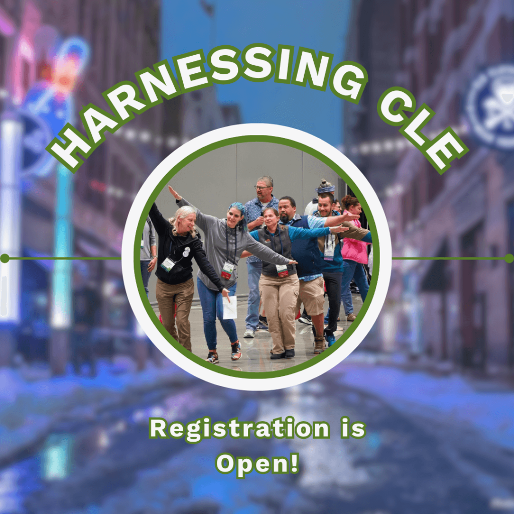 A circular photo of a team of people smile and laugh with their arms spread wide as they walk together, representing the scissor-tailed flycatcher that their team is named after. Around this, text reads, "Harnessing CLE Registration is Open!" while a blurred, snowy image of downtown Cleveland is seen in the background.