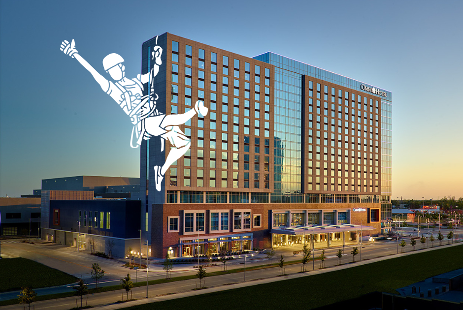 Over the Edge | ACCT International Annual Conference | Challenge Course, Ropes Course, Zip Line & Adventure Industry Event The exterior of the Oklahoma City Omni Hotel is seen with a graphic of a rappeler hanging off one side of the roof as they descend to the ground.