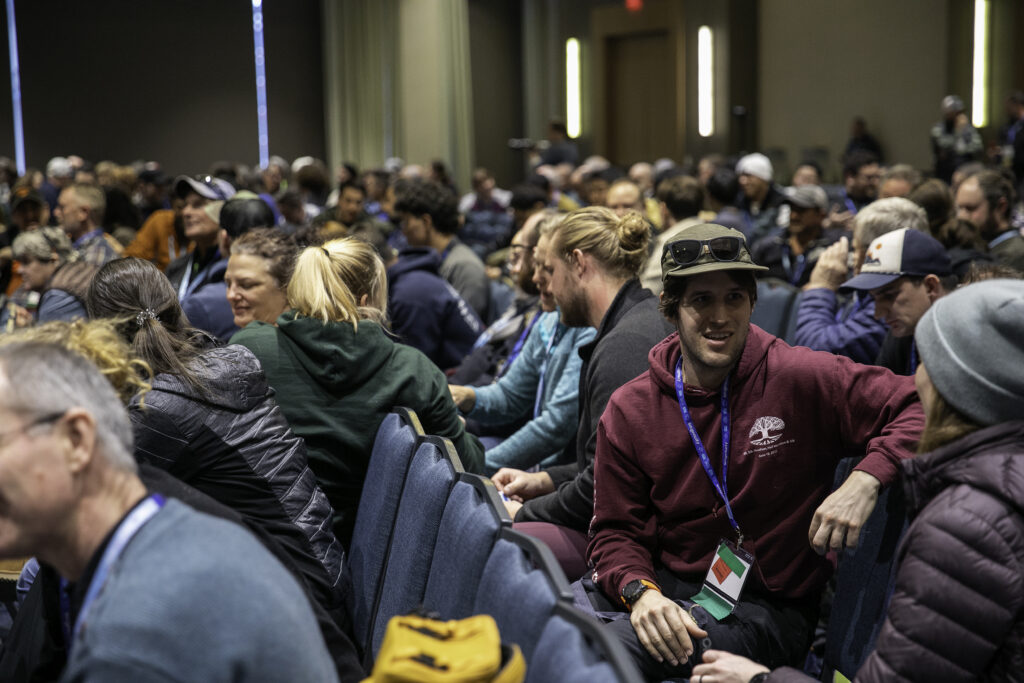 Attendees of the Opening Ceremony at the 2025 conference and exposition are seen chatting with their neighbors during an icebreaker facilitated by High 5.