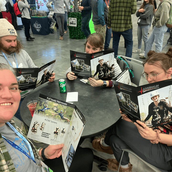 Four members of the Harnessing ACCT team Pawpaw Posse read books together in the Exhibit Hall during the 2025 conference and exposition.