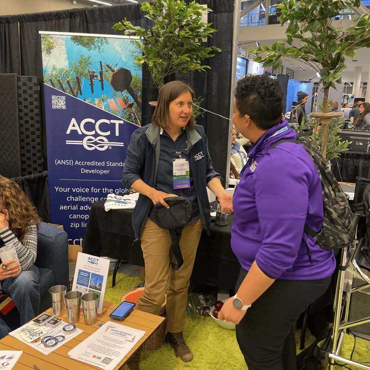 A member of the Harnessing ACCT team Trillium Troublemakers chats with ACCT Board Member Leslie Sohl at the ACCT Booth in the Exhibit Hall during the 2025 conference and exposition.