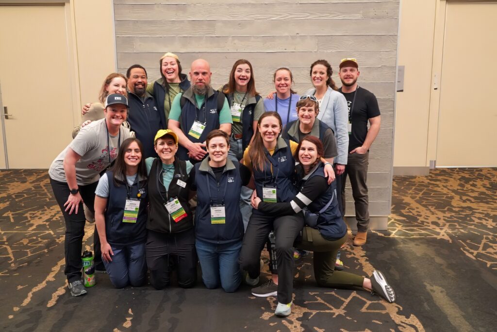 The members of the Conference Work Group smile together in the registration area of the 2024 ACCT conference and exposition.